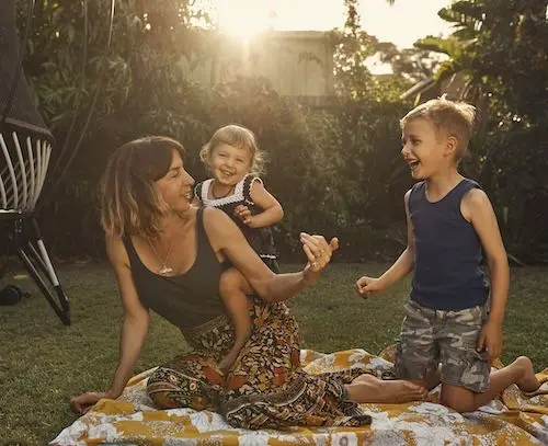 mother-and-two-kids-playing-in-yard.jpg