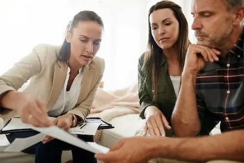 real-estate-agent-and-couple-reading-documents.jpg