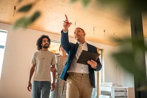 real-estate-agent-and-couple-indoors.jpg